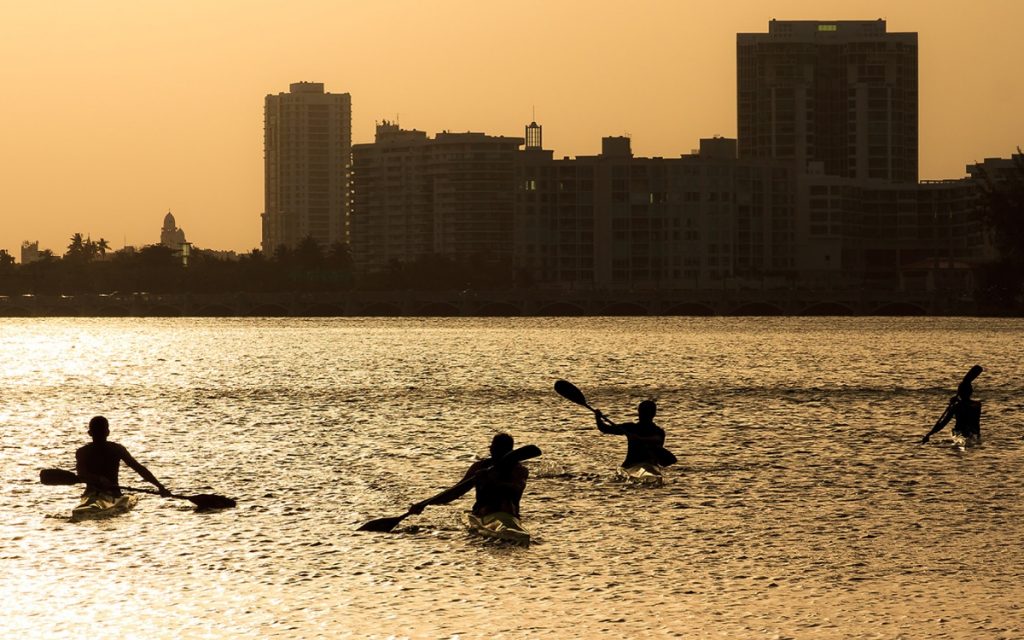 Silhouette of four people kayaking on Puerto Rico