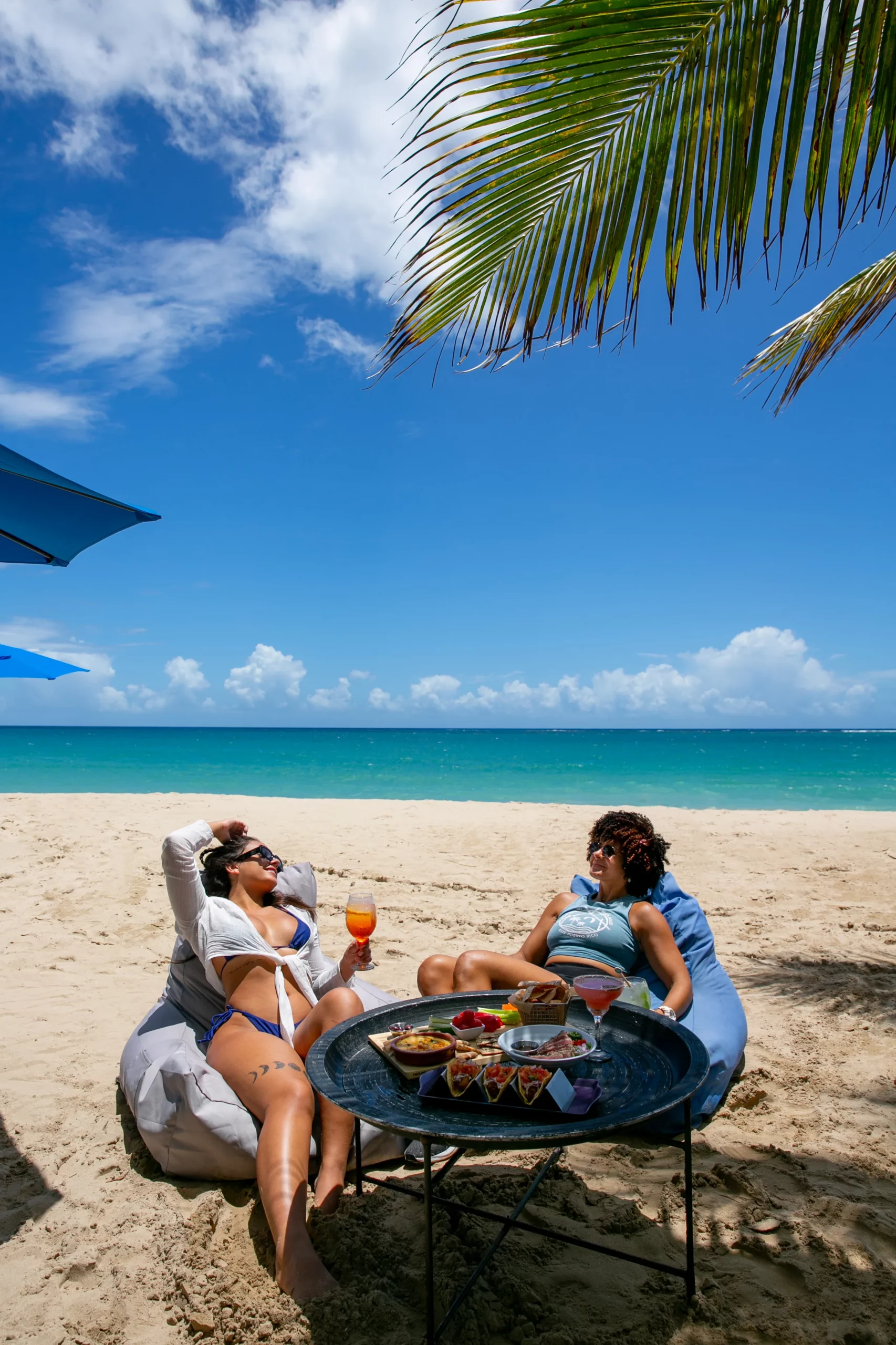customers enjoy food and drinks on the beach